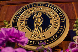 Photo of the UAlbany seal. Link to Gifts That Protect Your Assets.