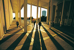 Photo of students walking in an outside corridor. Link to Gifts of Retirement Plans.